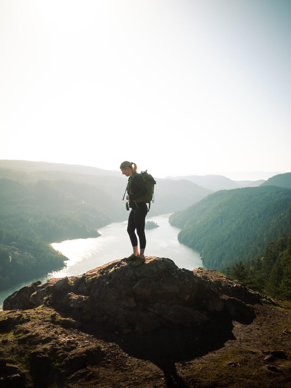 Woman on mountain above beautiful valley inspirational